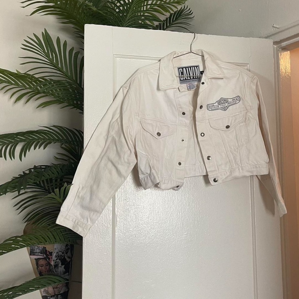rare calvin klein vintage white denim jacket. says “chase that dream”